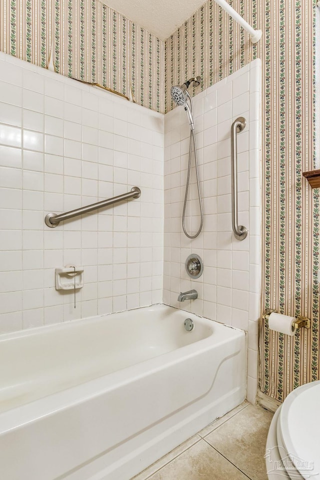 bathroom featuring tile patterned flooring and tiled shower / bath combo