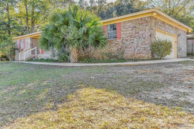 view of home's exterior with a lawn and a garage