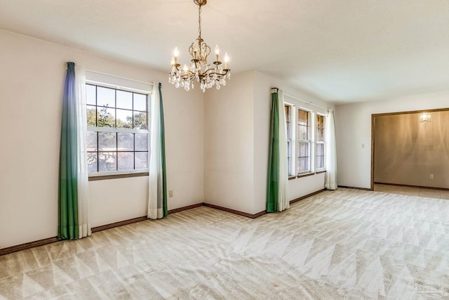 empty room with a chandelier and light colored carpet