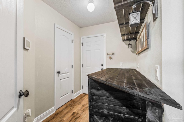 interior space featuring dark hardwood / wood-style floors and a textured ceiling