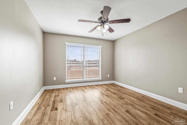 empty room featuring ceiling fan, a textured ceiling, and light wood-type flooring