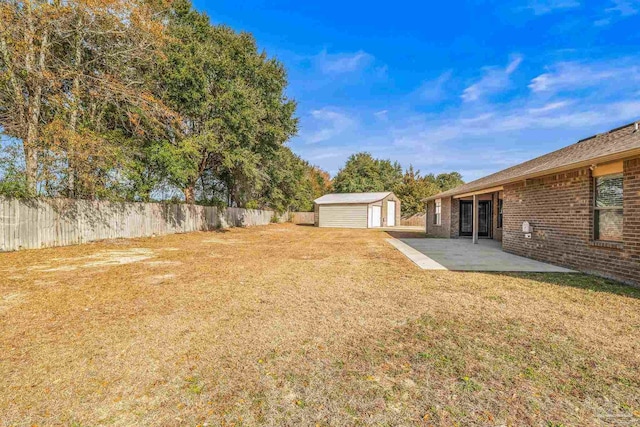 view of yard with a storage unit and a patio area