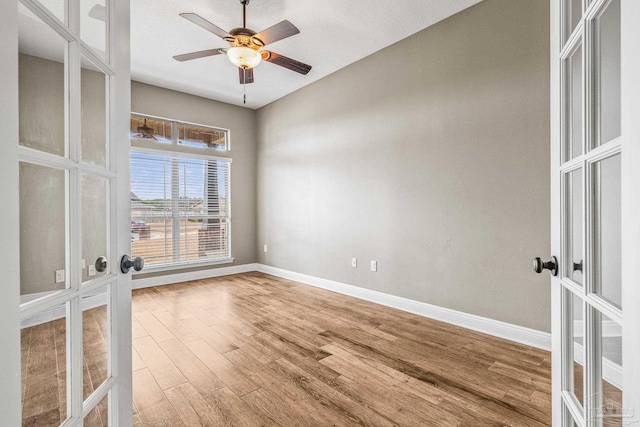 unfurnished room with hardwood / wood-style flooring, french doors, and ceiling fan