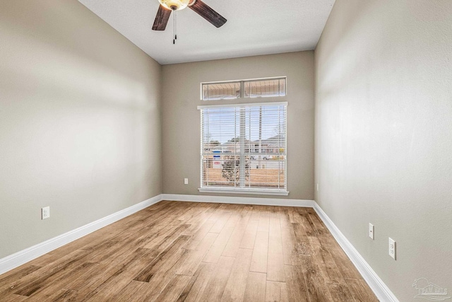 spare room with ceiling fan and hardwood / wood-style floors