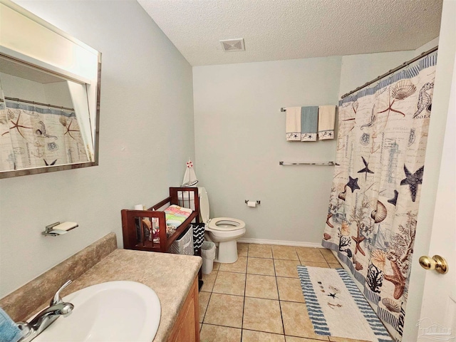 bathroom with toilet, a textured ceiling, vanity, and tile patterned flooring