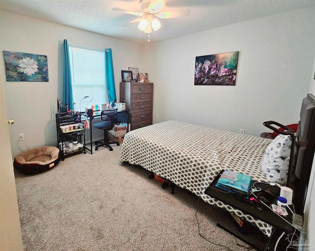 carpeted bedroom with ceiling fan and a textured ceiling