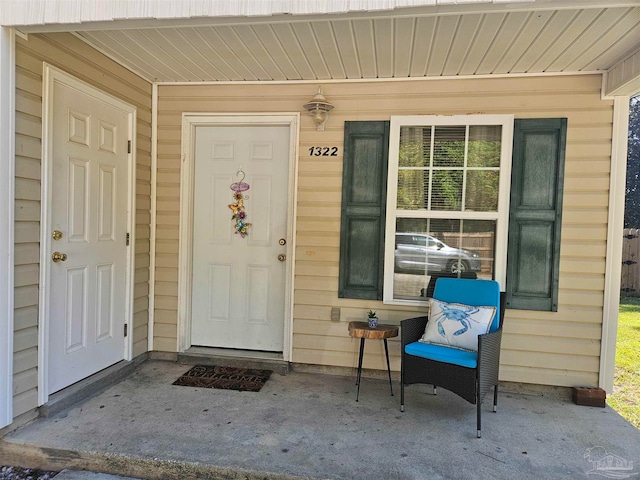 view of exterior entry with covered porch