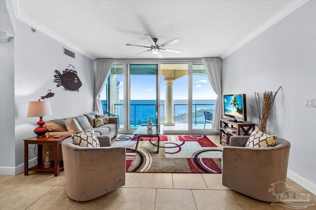 3 Portofino Dr Unit 1705, Pensacola Beach, FL 32561 - living room featuring crown molding, ceiling fan, baseboards, tile patterned flooring, and a textured ceiling