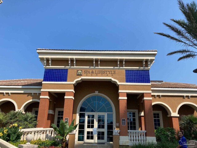 3 Portofino Dr Unit 1705, Pensacola Beach, FL 32561 - back of house featuring french doors and stucco siding
