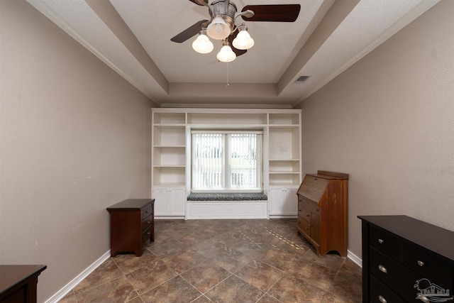 interior space featuring a tray ceiling and ceiling fan