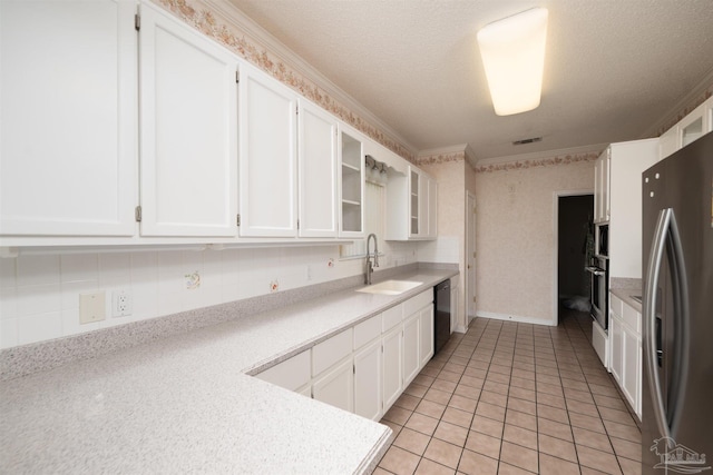 4181 Soundpointe Dr, Gulf Breeze, FL 32563 - kitchen with a sink, appliances with stainless steel finishes, white cabinetry, and light countertops