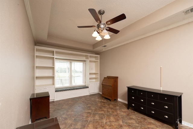 unfurnished bedroom featuring a textured ceiling, a tray ceiling, and ceiling fan