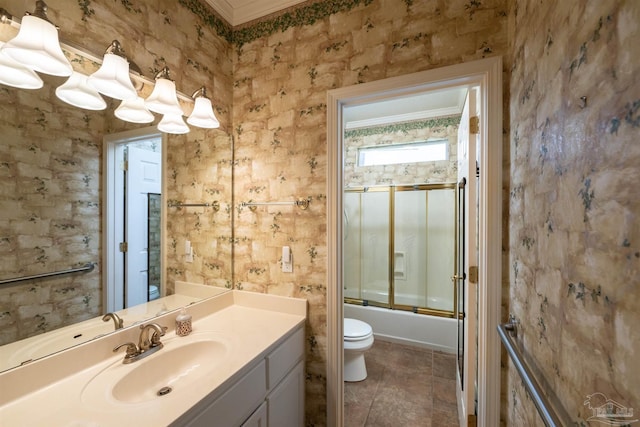 4181 Soundpointe Dr, Gulf Breeze, FL 32563 - full bathroom with crown molding, vanity, tile patterned floors, toilet, and shower / bath combination with glass door
