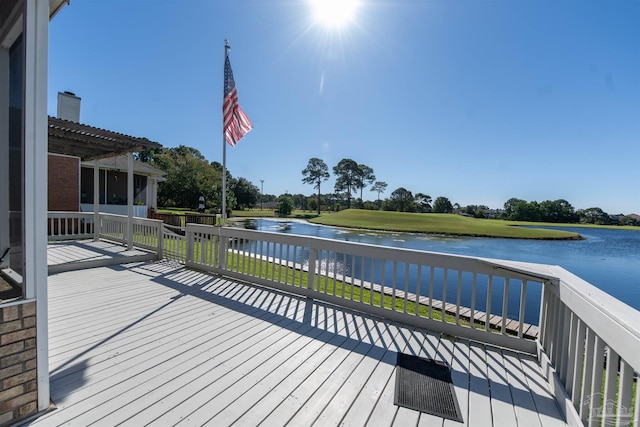 wooden deck with a yard, a water view, and a pergola