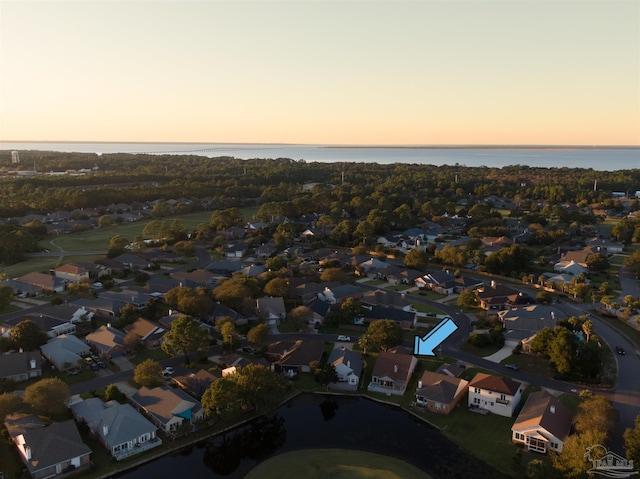 aerial view at dusk with a water view