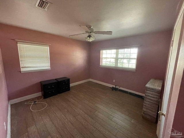 spare room with dark hardwood / wood-style floors and ceiling fan