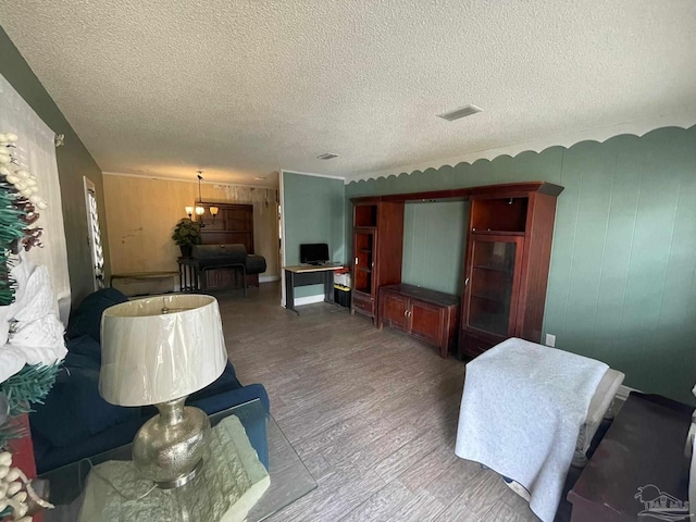 living room featuring wood-type flooring and a textured ceiling