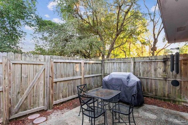 3382 Green Briar Cir, Gulf Breeze, FL 32563 - fenced backyard featuring a grill, a patio, and outdoor dining space
