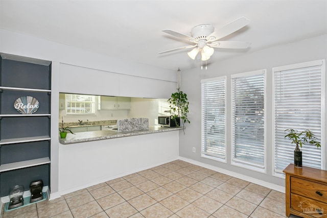 3382 Green Briar Cir, Gulf Breeze, FL 32563 - kitchen with ceiling fan, light tile patterned flooring, and stainless steel microwave