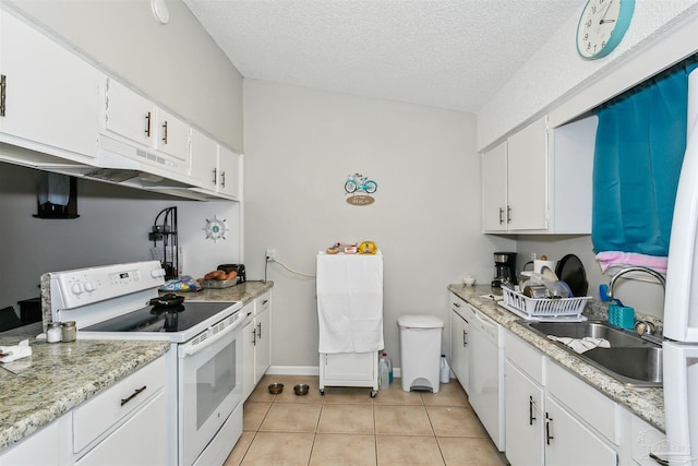 3382 Green Briar Cir, Gulf Breeze, FL 32563 - kitchen with white appliances, under cabinet range hood, light tile patterned floors, light countertops, and white cabinets