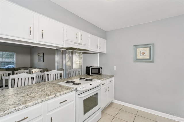3382 Green Briar Cir, Gulf Breeze, FL 32563 - kitchen with white range with electric stovetop, stainless steel microwave, under cabinet range hood, light tile patterned flooring, and white cabinets