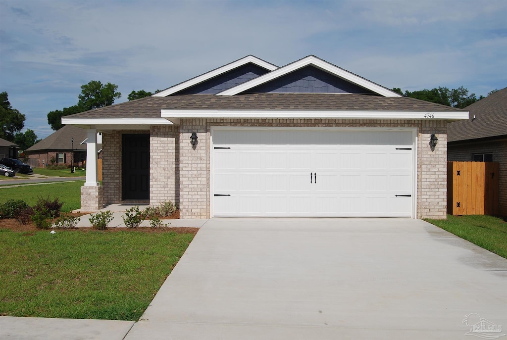 4746 Majestic Palm St, Pace, FL 32571 - view of front of home featuring brick siding, concrete driveway, an attached garage, and a front yard