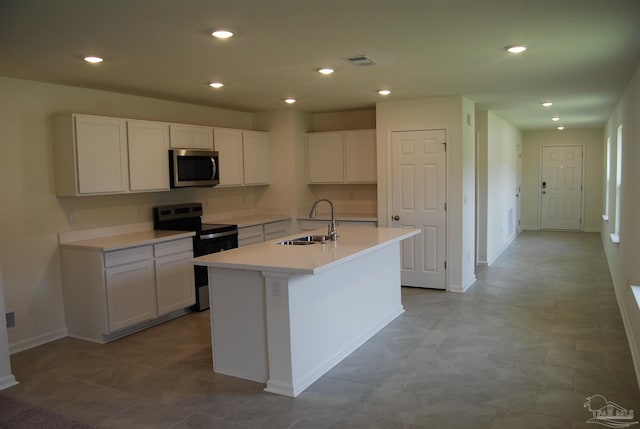 4746 Majestic Palm St, Pace, FL 32571 - kitchen with stainless steel appliances, white cabinetry, a kitchen island with sink, recessed lighting, and light countertops