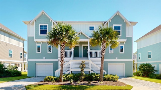 14379 Cordgrass Ln, Pensacola, FL 32507 - coastal inspired home featuring stairs, gravel driveway, covered porch, and an attached garage