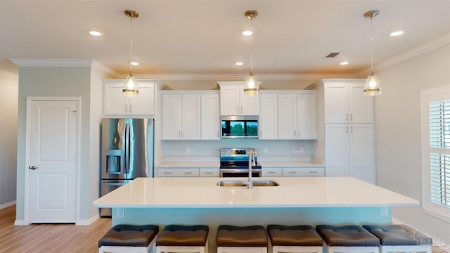 kitchen featuring white cabinets, appliances with stainless steel finishes, and a healthy amount of sunlight