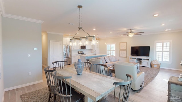 dining space with ceiling fan, light wood-type flooring, and a wealth of natural light