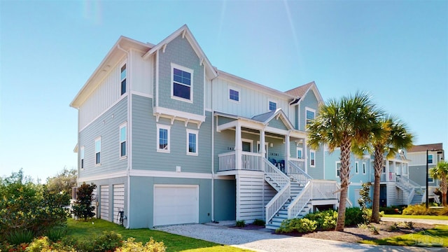 14379 Cordgrass Ln, Pensacola, FL 32507 - coastal inspired home featuring driveway, covered porch, an attached garage, and stairway