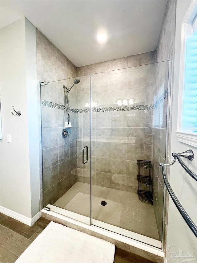 14379 Cordgrass Ln, Pensacola, FL 32507 - bathroom featuring baseboards, wood finished floors, and a shower stall