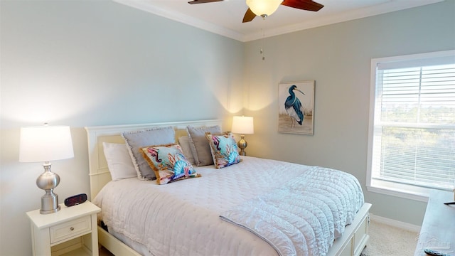 bedroom featuring ornamental molding, ceiling fan, and light colored carpet