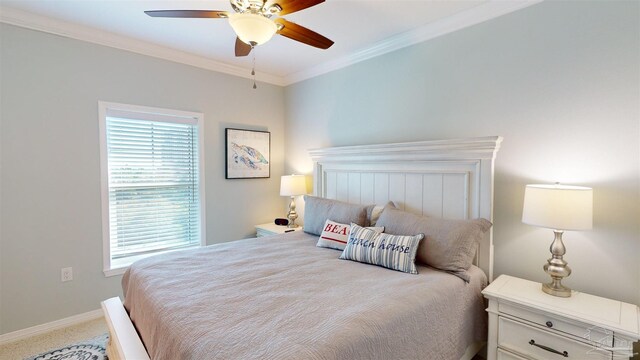 carpeted bedroom with crown molding and ceiling fan