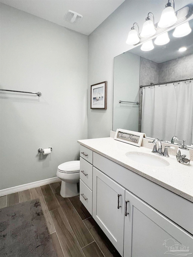 bathroom featuring vanity, hardwood / wood-style floors, toilet, and a shower with shower curtain