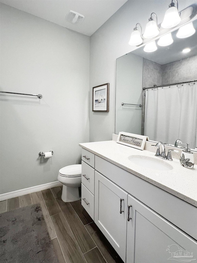 14379 Cordgrass Ln, Pensacola, FL 32507 - bathroom featuring toilet, vanity, baseboards, wood tiled floor, and visible vents