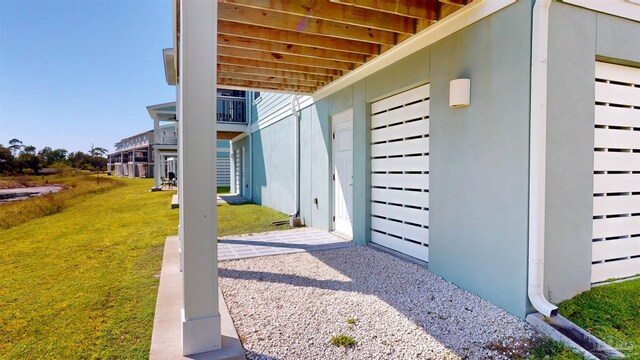 14379 Cordgrass Ln, Pensacola, FL 32507 - exterior space with stucco siding and a lawn