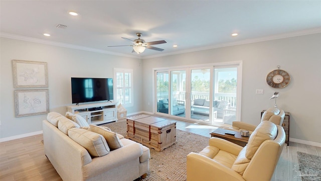 living room featuring light wood-type flooring, ceiling fan, and crown molding