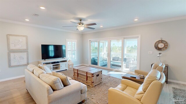 14379 Cordgrass Ln, Pensacola, FL 32507 - living room featuring visible vents, crown molding, baseboards, a ceiling fan, and light wood-style floors