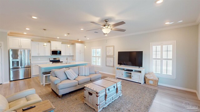 14379 Cordgrass Ln, Pensacola, FL 32507 - living area featuring light wood-style flooring, crown molding, and ceiling fan