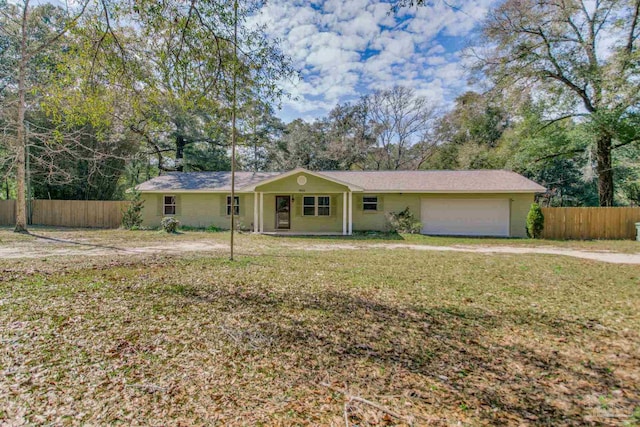 single story home featuring an attached garage, fence, and a front yard