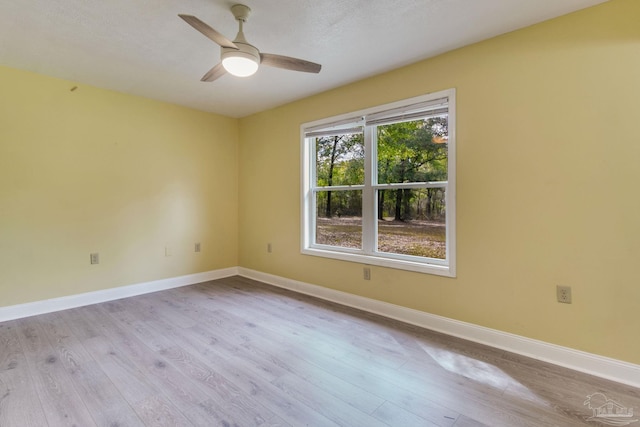 unfurnished room with ceiling fan, baseboards, and wood finished floors