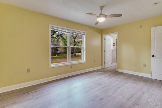 spare room with a ceiling fan, baseboards, and wood finished floors