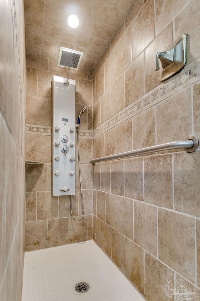 bathroom with visible vents and a tile shower