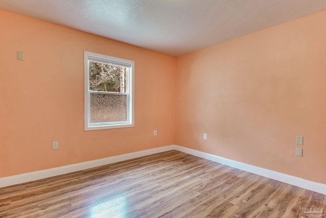 unfurnished room featuring light wood-style flooring and baseboards