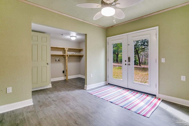 doorway to outside with french doors, crown molding, baseboards, and wood finished floors