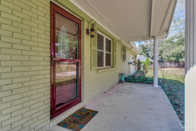 view of exterior entry with a porch