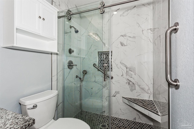 bathroom featuring toilet and an enclosed shower