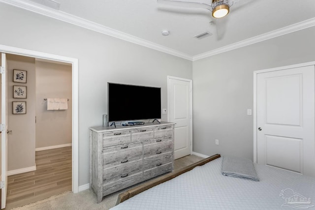 bedroom featuring crown molding, ceiling fan, and light hardwood / wood-style floors