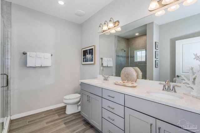 bathroom featuring toilet, vanity, and walk in shower